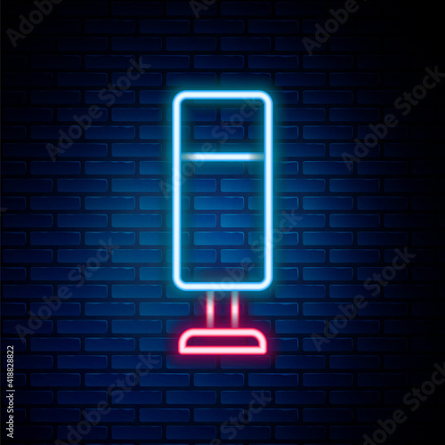 Glowing neon line Punching bag icon isolated on brick wall background. Colorful outline concept. Vector.