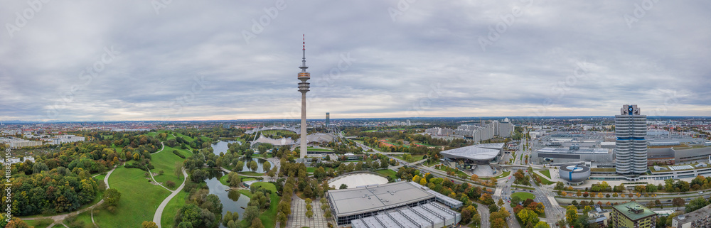 Obraz premium Panoramic aerial view over Munich, typical and authentic pano shot over the green olympic park, modern living at it's best.