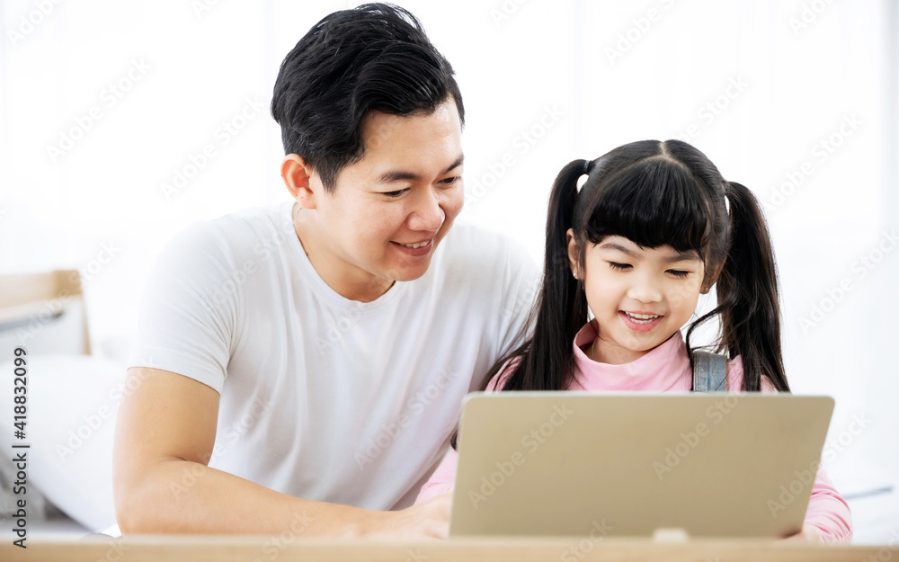 Father and daughter learning education study online class. Kid girl and dad using computer laptop at home Father and daughter learning education study online class. Kid girl and dad using computer laptop at home