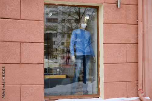 Wallpaper Mural Mannequin wearing a medical mask in the shop window. Coronavirus pandemic. Torontodigital.ca