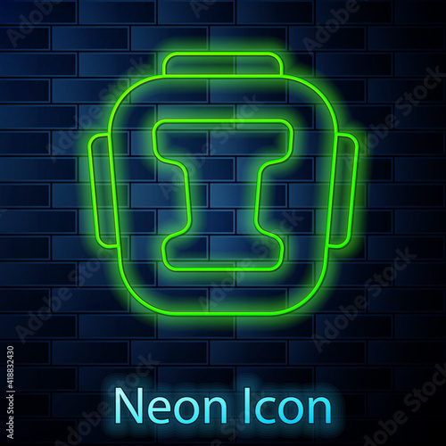 Glowing neon line Boxing helmet icon isolated on brick wall background. Vector.
