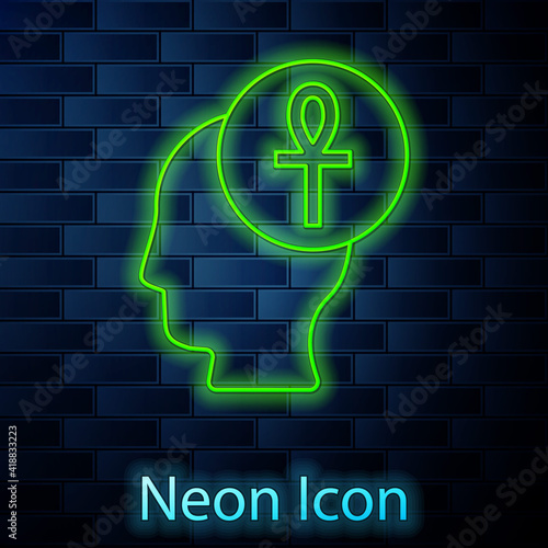 Glowing neon line Cross ankh icon isolated on brick wall background. Vector.