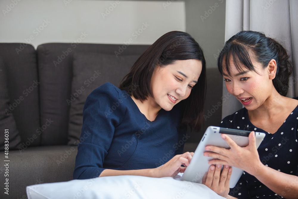 asian young woman using tablet relax working and shopping online on bedroom in hotel. online work leisure day. asian young woman using tablet relax working and shopping online on bedroom in hotel. online work leisure day.