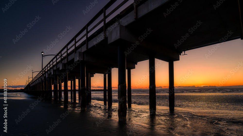 Sun Setting over Canada's Longest Pier in Semiahmoo Bay at the village of White Rock in British Columbia, Canada