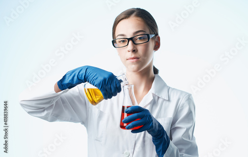 woman doctor professional with vaccine flasks in hand analyzes