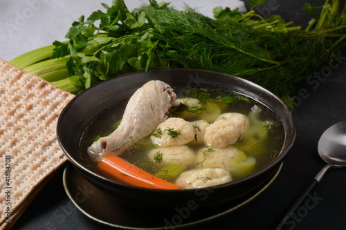 Chicken Matzo ball soup with carrots in the bowl. Jewish traditional Passover holiday food photo