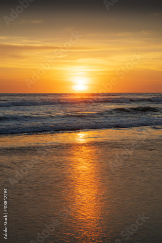 Sunset and beach. Seascape background. Bright sunlight. Sun at horizon line. Scenic view. Sunset golden hour. Sunlight reflection in water. Magnificent scenery. Copy space. Bali