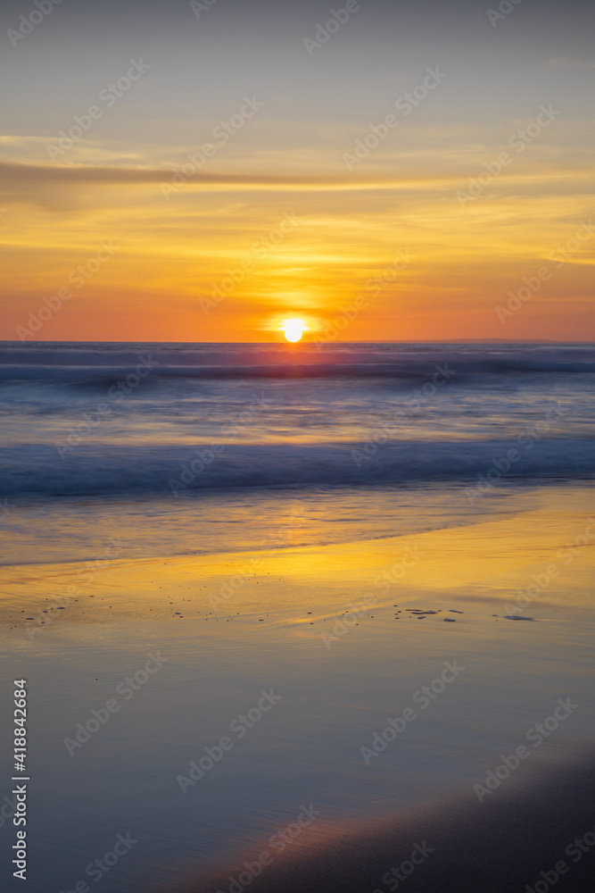 Sunset and beach. Seascape background. Bright sunlight. Sun at horizon line. Scenic view. Sunset golden hour. Sunlight reflection in water. Magnificent scenery. Copy space. Bali