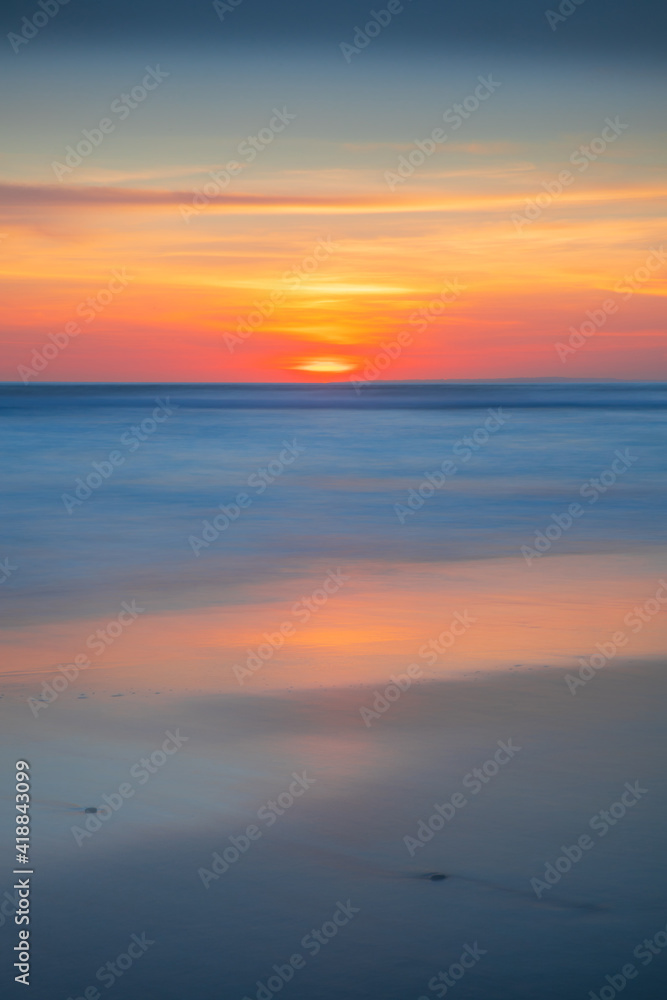 Sunset and beach. Seascape background. Bright sunlight. Sun at horizon line. Scenic view. Colorful sky. Sunlight reflection in water. Magnificent scenery. Copy space. Bali
