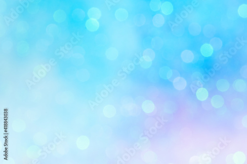 Soft bokeh in pastel colors. A fairy tale gradient of light blue and purple with shiny circles on the background.