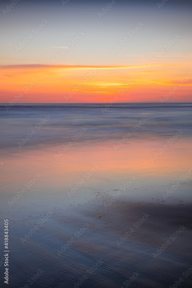 Sunset seascape. Slow shutter speed. Colorful sky. Amazing water reflection. Nature and environment background. Soft focus. Silky water. Copy space. Beach in Bali. Sunset seascape. Slow shutter speed. Colorful sky. Amazing water reflection. Nature and environment background. Soft focus. Silky water. Copy space. Beach in Bali.