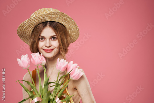 Pretty woman in hat bouquet flowers holiday gift pink background © SHOTPRIME STUDIO