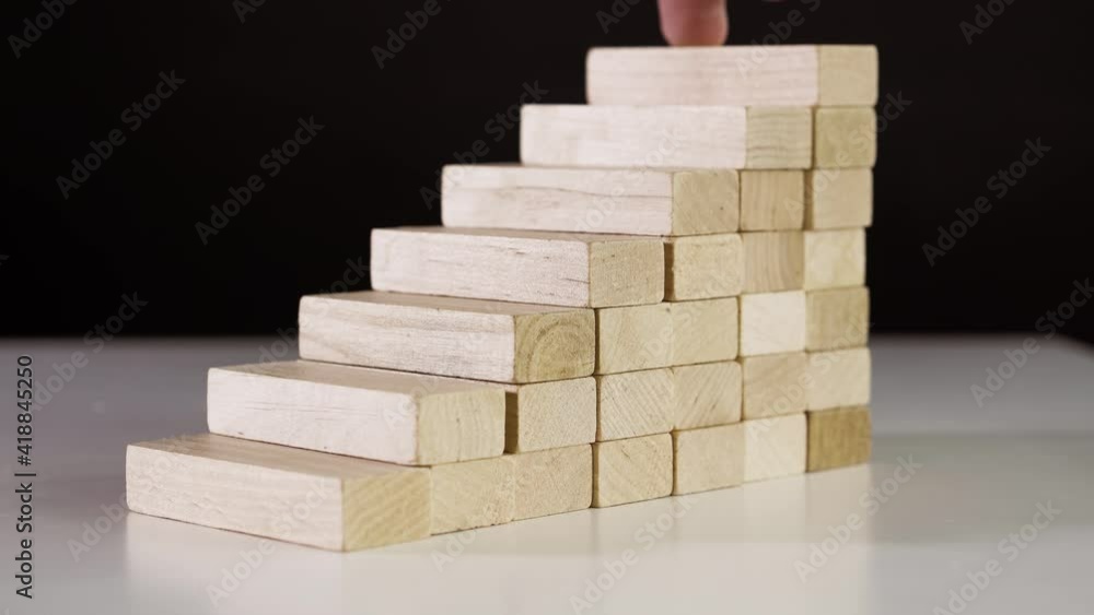 Hand walk on wood block stacking as step stair. Moving up a career ladder. business concept Hand walk on wood block stacking as step stair. Moving up a career ladder. business concept