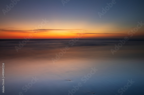 Wallpaper Mural Sunset seascape. Slow shutter speed. Soft focus. Silky water. Black sand beach. Colorful sky. Amazing water reflection. Nature and environment background. Copy space. Sunset in Bali. Torontodigital.ca