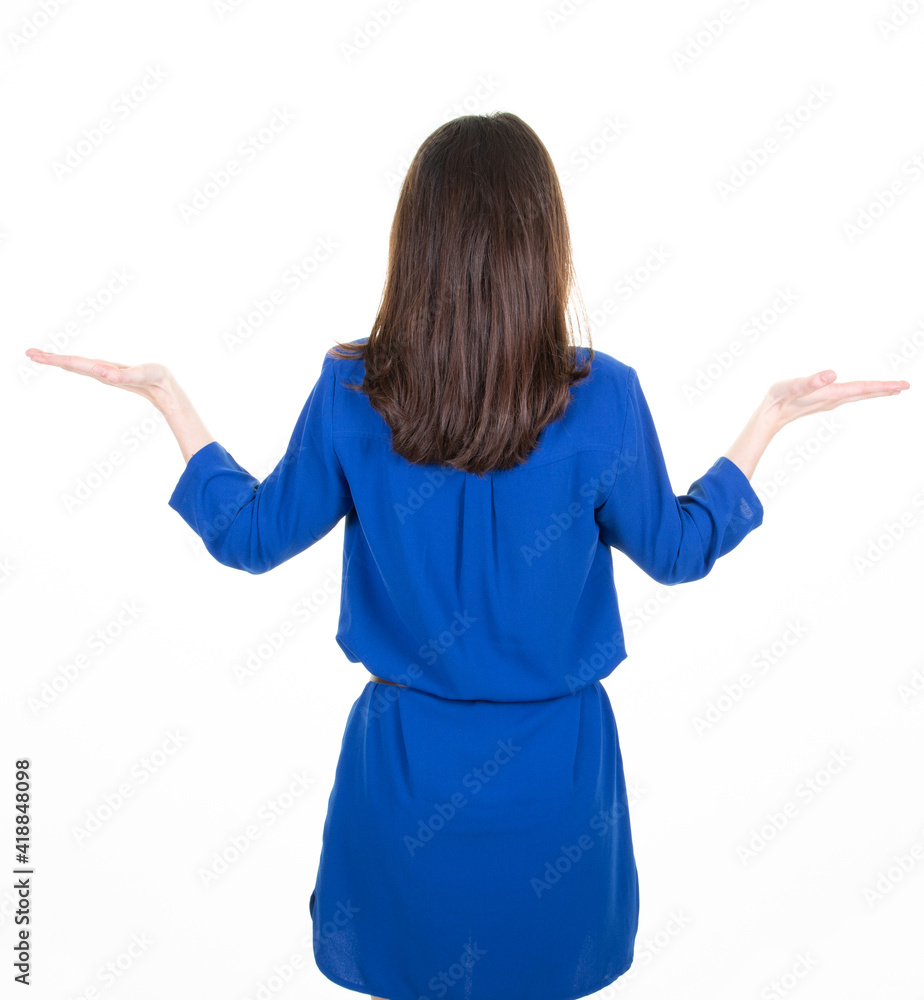 behind rear view slim brunette woman in blue dress showing her two empty palms space behind rear view slim brunette woman in blue dress showing her two empty palms space