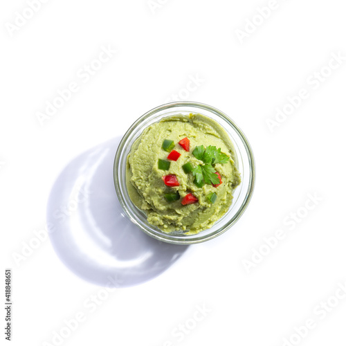 Guacamole glass bowl isolated on white background with copy space. Top view.