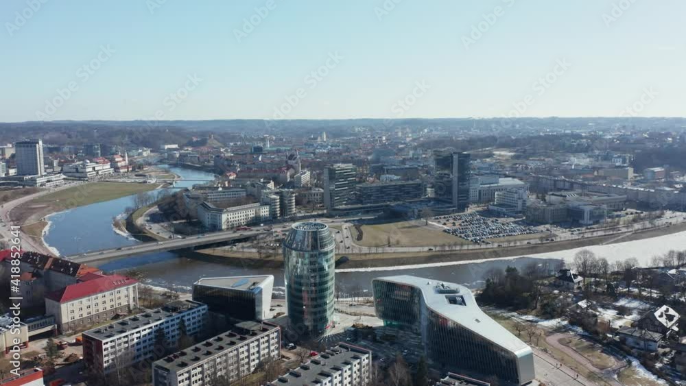 AERIAL: Rotating Shot of Vilnius Panorama with River Bank Neris and Office Buildings in the Background AERIAL: Rotating Shot of Vilnius Panorama with River Bank Neris and Office Buildings in the Background