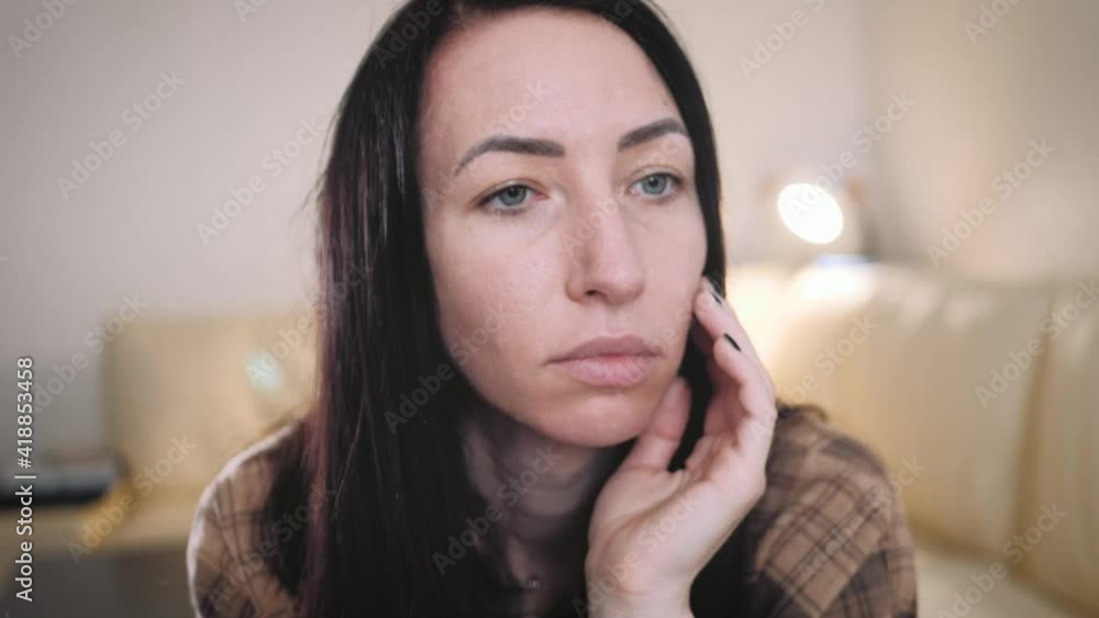 Depressed worried beautiful young woman feeling nervous, upset about problem. Thinking of mental stress concept. Nervous young lady feeling unsure about hard decision, sitting alone on sofa. Depressed worried beautiful young woman feeling nervous, upset about problem. Thinking of mental stress concept. Nervous young lady feeling unsure about hard decision, sitting alone on sofa.