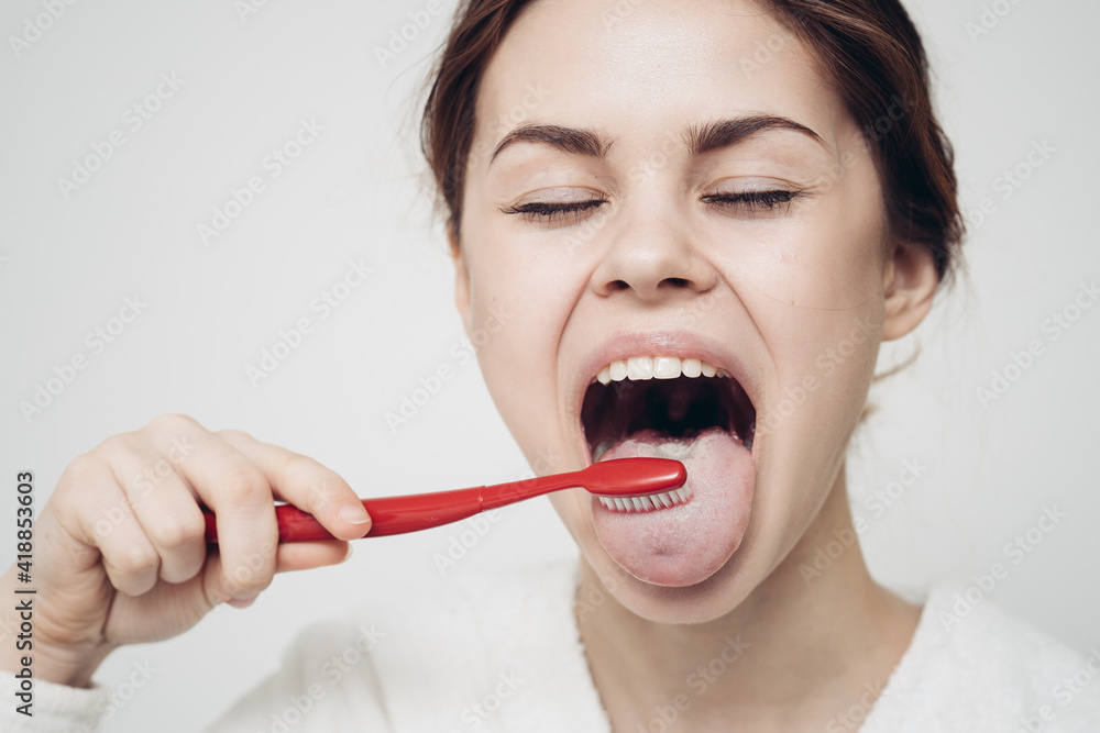 pretty woman in white robe brushing tongue hygiene pretty woman in white robe brushing tongue hygiene