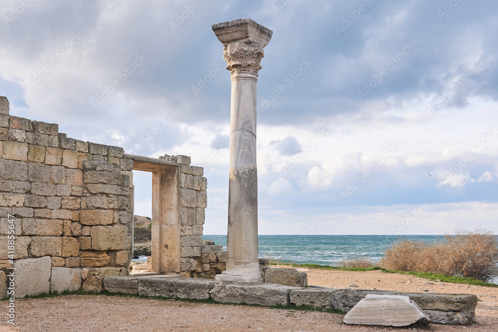ruins of antique greek temple with column on the seashore