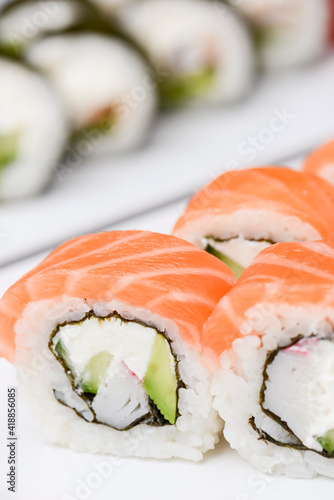 Maki Sushi - Roll made of smoked salmon and cream cheese. Traditional Japanese cuisine concept, over white background.