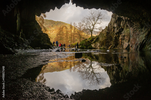 Rydal Cave view outside with a reflection in the water in the lake district on a sunny day. Abandoned slate quarry  photo