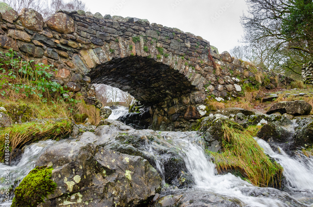 Ashness Stone Bridge over a small river near Keswick Lake District National Park Cumbria England UK Ashness Stone Bridge over a small river near Keswick Lake District National Park Cumbria England UK