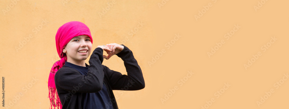 portrait of smiling girl with headscarf and making heart symbol with hands portrait of smiling girl with headscarf and making heart symbol with hands