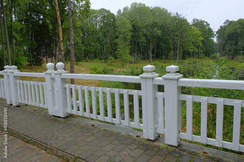Beautiful wooden white fence on the background of a picturesque forest