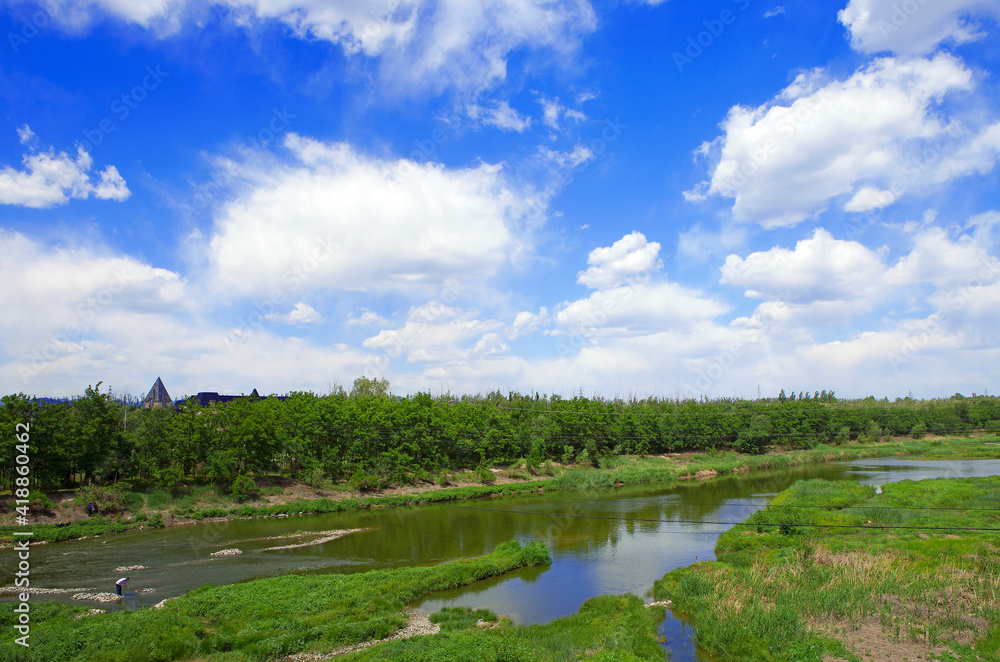 Beautiful cloudy blue sky and a river with green vegetation Beautiful cloudy blue sky and a river with green vegetation