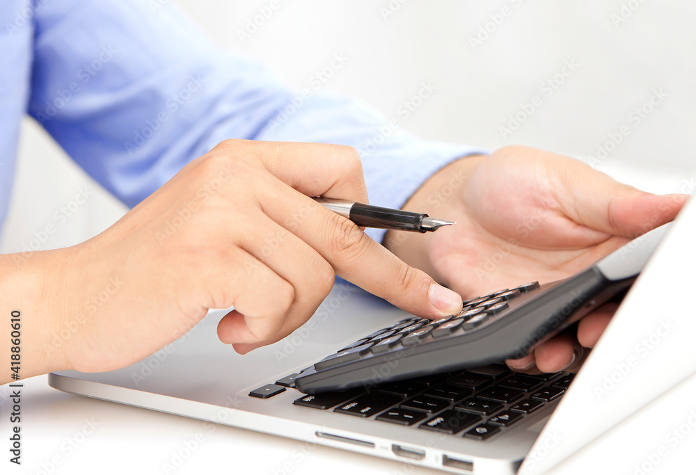 Fototapeta premium Businessman is calculating on desk