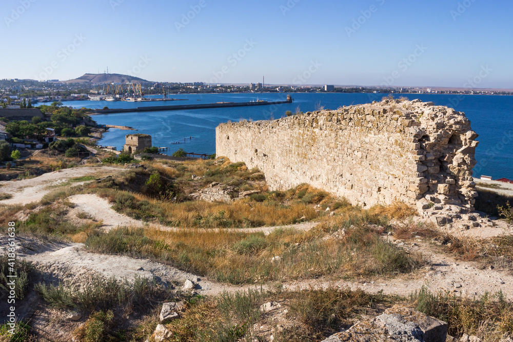 The Bay of Feodosia, the Black Sea, Crimea. The ruins of the Dock tower of the Genoese fortress. The ruins of the Armenian fortress.