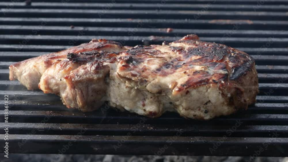 meat steak fried on a wire rack with smoke and fire meat steak fried on a wire rack with smoke and fire