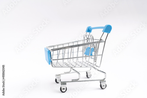 Shopaholic. Buyer. Shopping concept. Close-up. Isolated shopping trolley on a white background. © apiwat