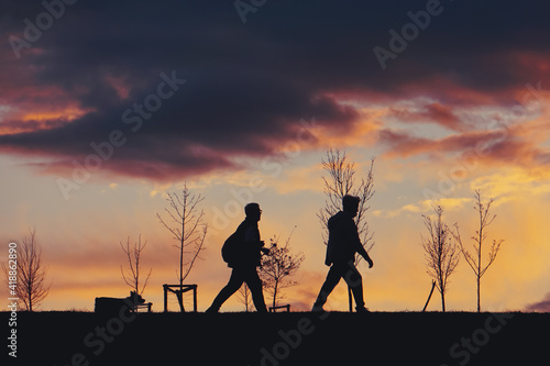 people silhouette and sunset in the mountain