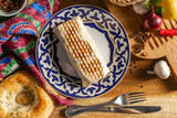 Shawarma on the grill on a plate with traditional Uzbekistan ornament