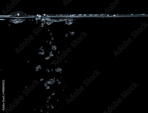 Bubble soda and white oxygen air, in underwater clear liquid with bubbles flowing up on the water surface, On a black background