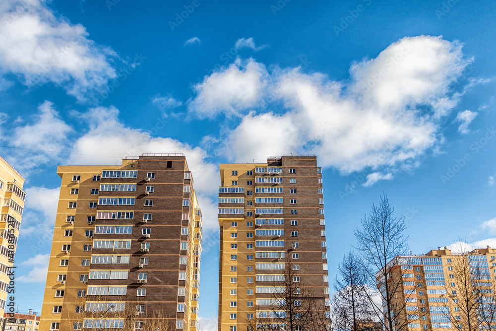 Urban architecture, multi-storey residential buildings against a cloudy sky.. Urban architecture, multi-storey residential buildings against a cloudy sky..