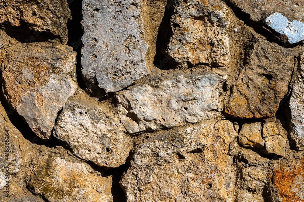 Decorative wall made of natural stone of various shapes and sizes. Interior background