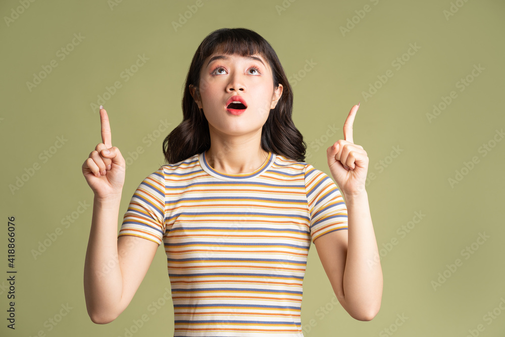 Young beautiful Asian woman posing on background Young beautiful Asian woman posing on background