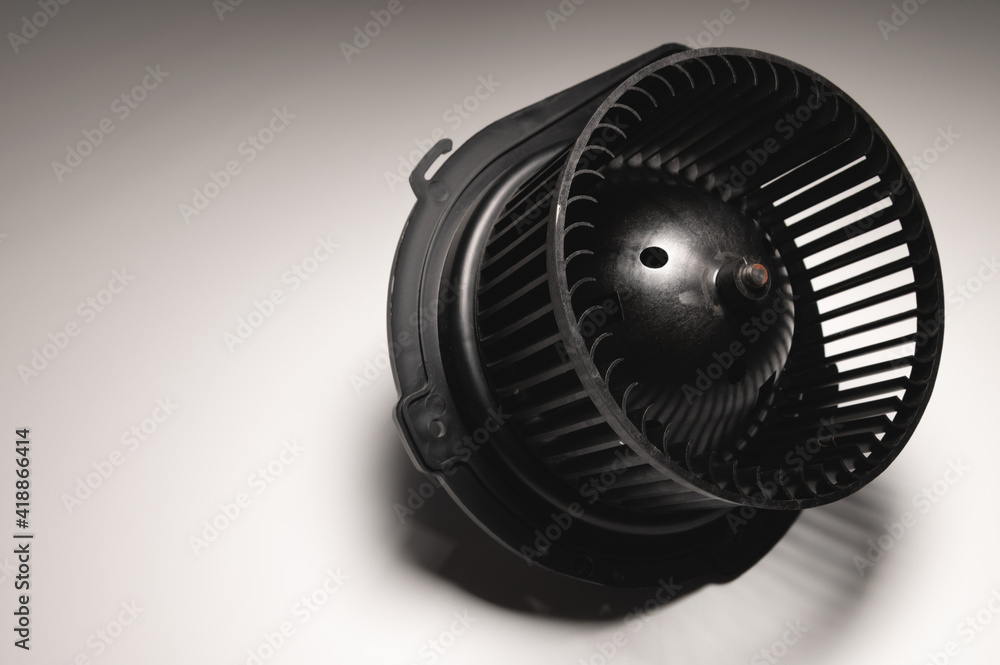 Heater motor. Spare part of car heating system on gray background Heater motor. Spare part of car heating system on gray background