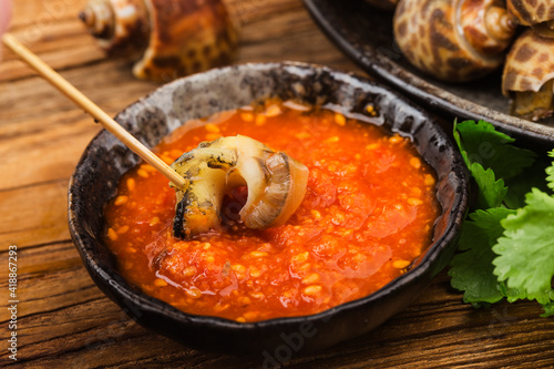 Babylonia areolata shellfish seafood on bowl ready for eat or cooked photo