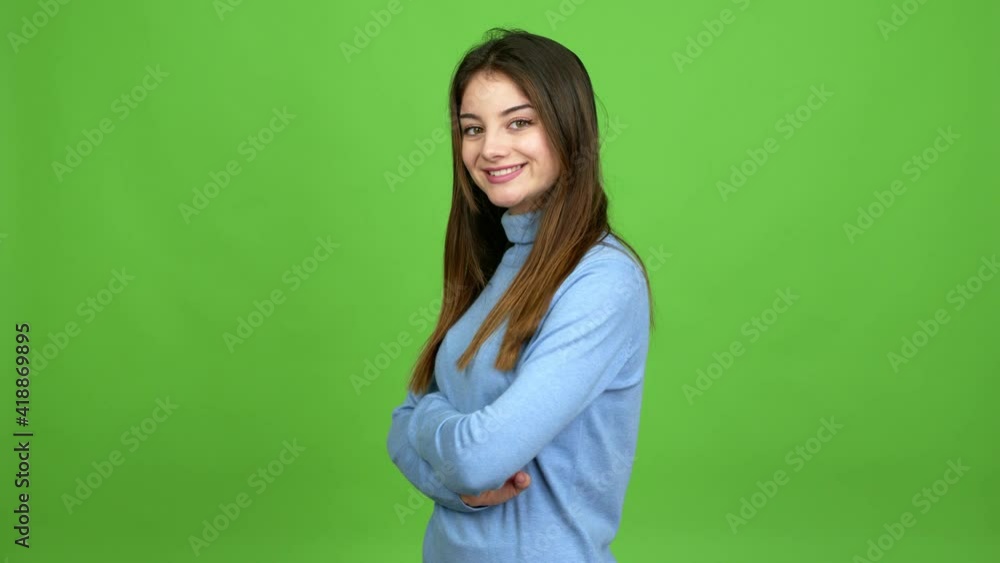 Young caucasian woman keeping the arms crossed in confident expression over isolated background. Green screen chroma key Young caucasian woman keeping the arms crossed in confident expression over isolated background. Green screen chroma key