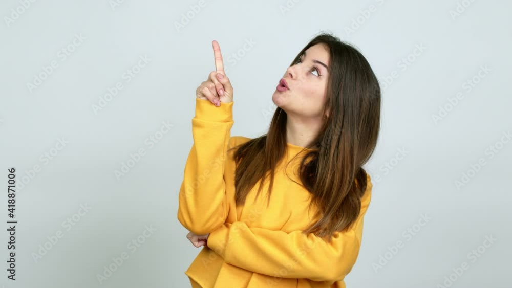 Young caucasian woman pointing a great idea and looking up over isolated background Young caucasian woman pointing a great idea and looking up over isolated background