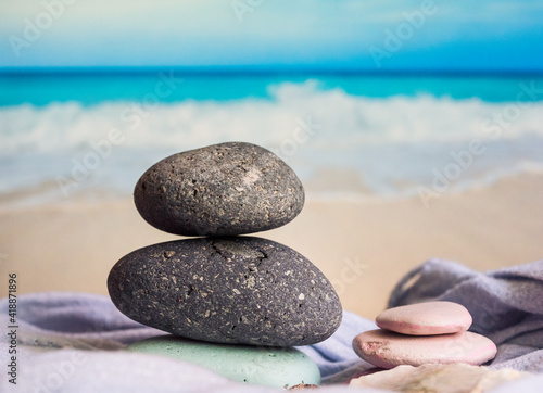 Overlapping stones on the sea view and beach in the background.