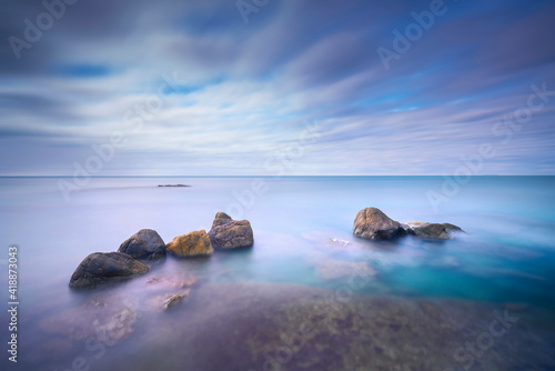 Rocks and soft sea, long exposure photography landscape.