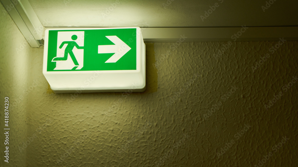 Emergency exit sign on wall in house as a notice sign Emergency exit sign on wall in house as a notice sign