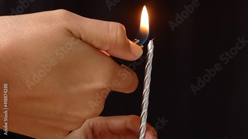 light a candle with a gaslighter photo