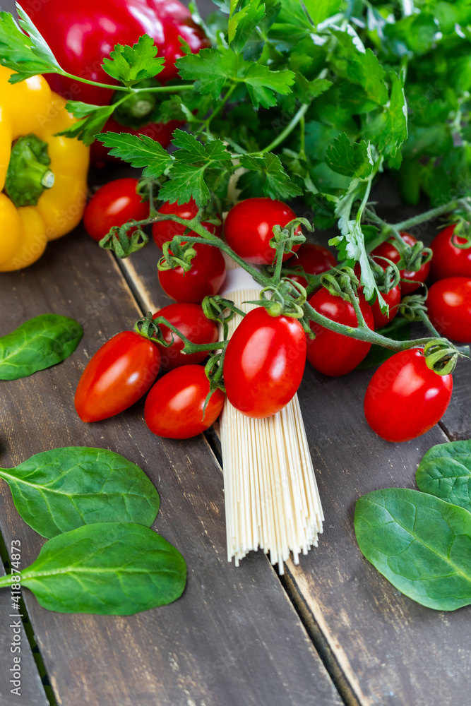 Closeup view of noodles pasta with fresh organic vegetables on wooden background.Vertical colorful healthy food concept Closeup view of noodles pasta with fresh organic vegetables on wooden background.Vertical colorful healthy food concept