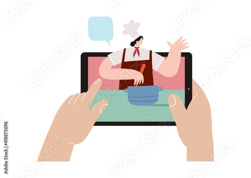 A young woman cooks at home in isolation and in quarantine and watches a cook’s video workshop online. Vector illustration - online cooking in a mobile device or tablet.